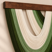Close view of green and cream looped cord meeting the dark stained batten