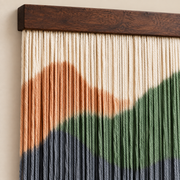 Close view of thick dip dyed cord bands below the dark stained wood batten