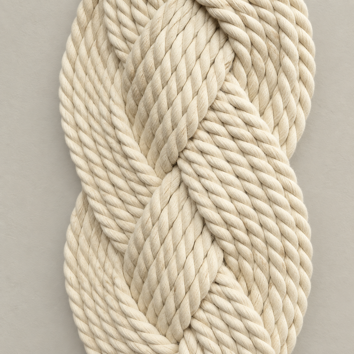 Macro of the plaited rope showing the twist of each ply, plaited rope column in cream