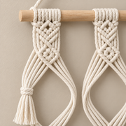 Close view of the knotted cord and an open hat loop on the wooden dowel