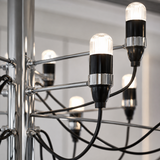 Close-up of a chandelier with multiple light bulbs and intricate wiring.