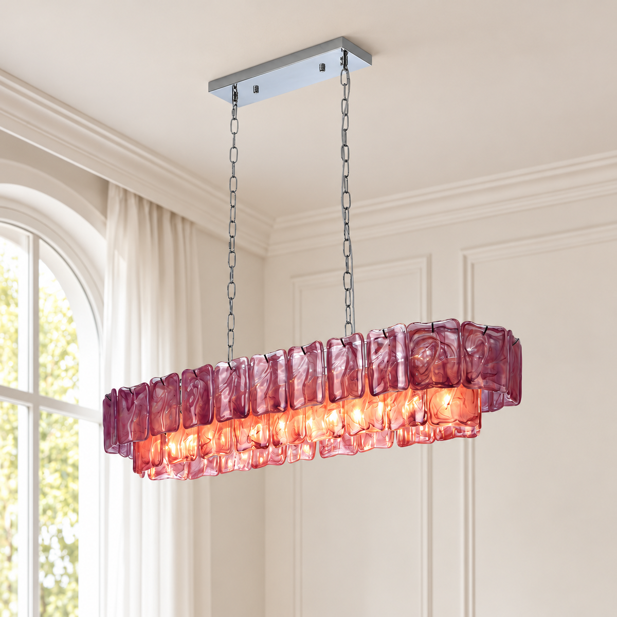 A linear chandelier with purple rippled glass panels glows beneath a silver ceiling canopy in a cream room with an arched window.