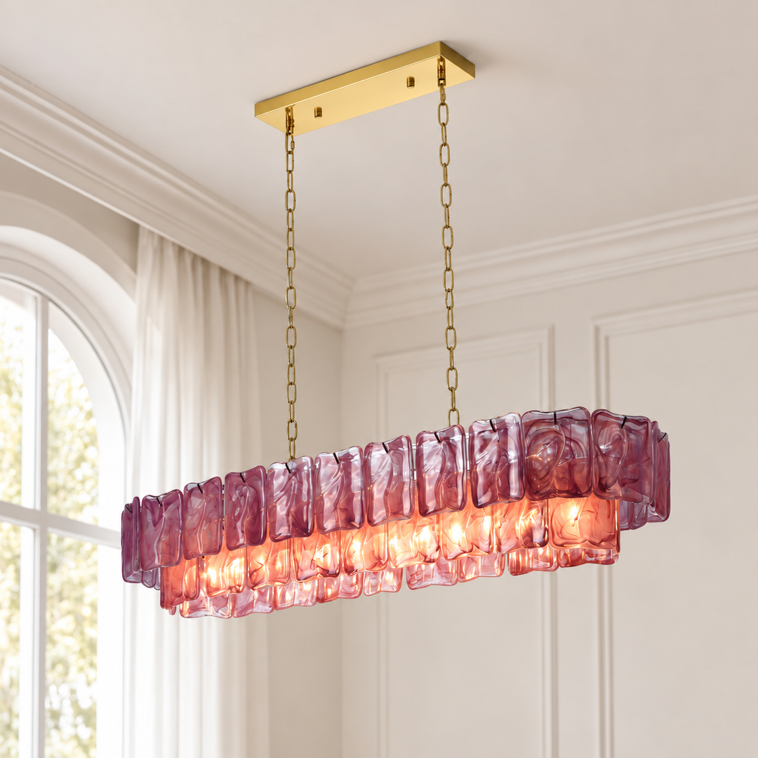 An illuminated purple glass linear chandelier hangs from gold-toned chains and a matching canopy beside an arched window.