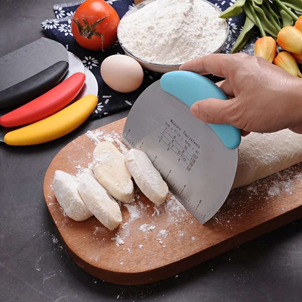 Hand using a blue-handled bench scraper to cut dough on a board beside flour and eggs
