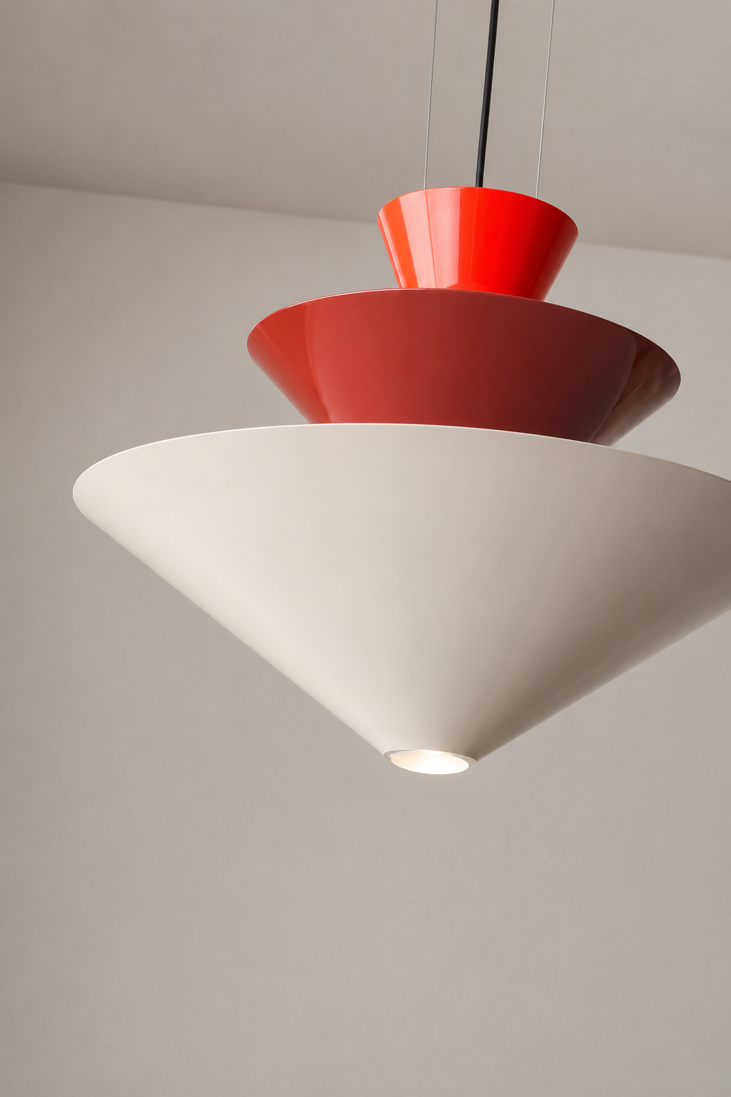 Modern pendant light with red and white design on a plain background