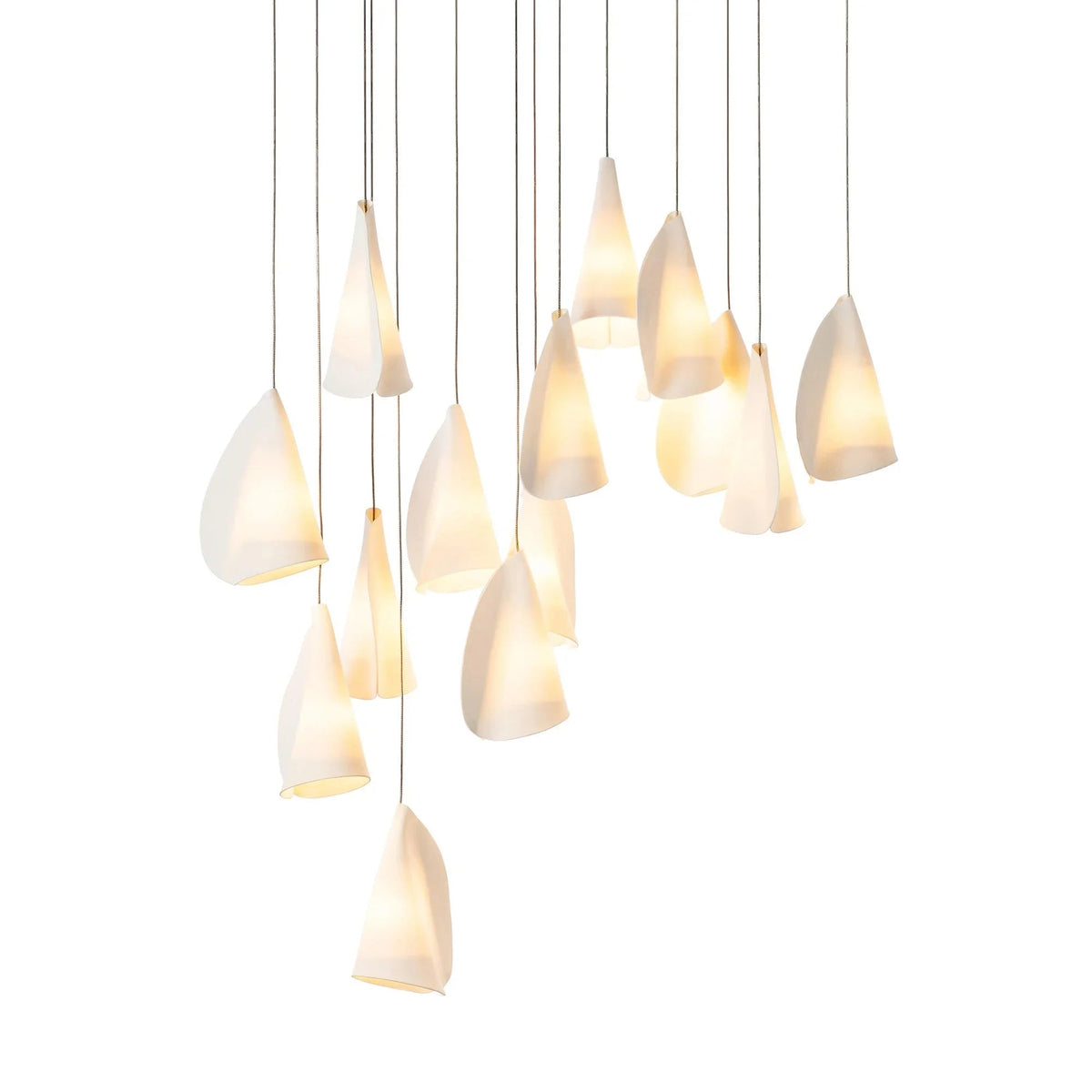 White porcelain chandelier with folded shades glowing at staggered heights on thin dark cords against a white background.