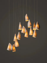 Modern chandelier with cone-shaped lights on a dark background