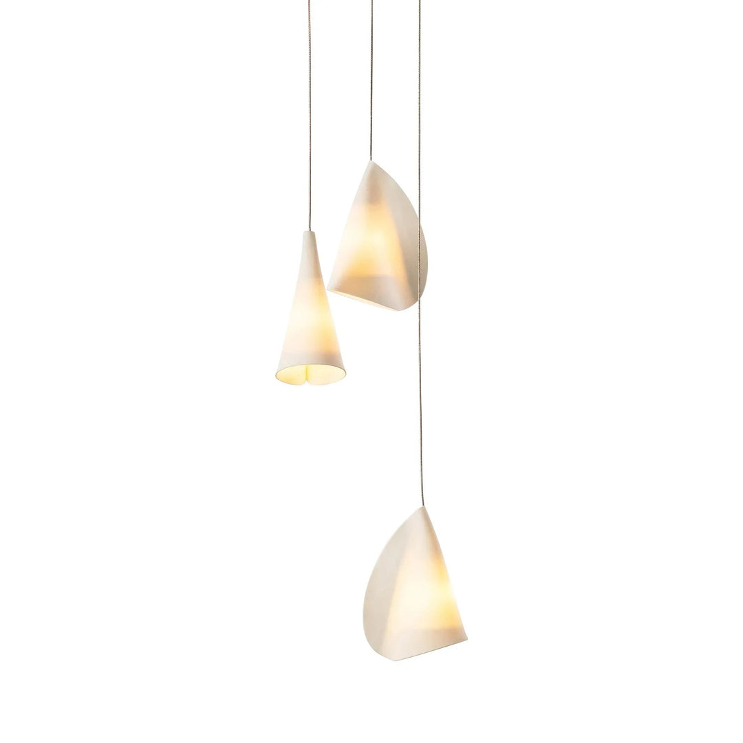 Chandelier with three folded white porcelain shades viewed from another angle against a white background.