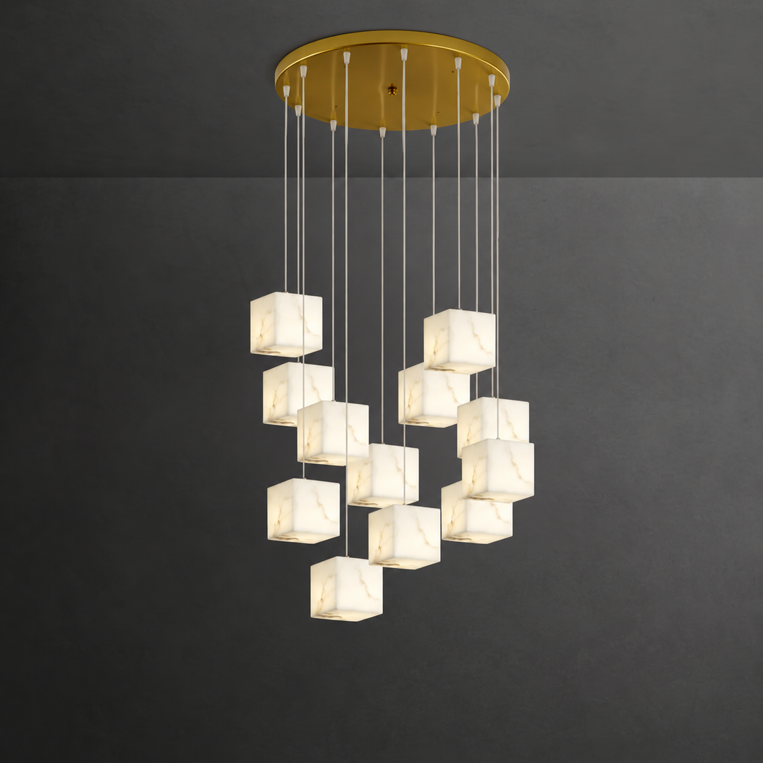 A modern multi-light chandelier with a circular gold ceiling canopy and multiple hanging square marble shades, shown against a dark gray wall.