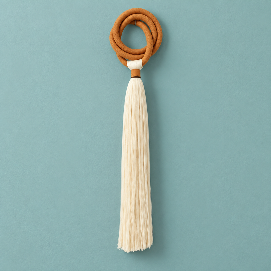 Studio on teal, full piece, terracotta ring and long tassel, wrapped cord ring, fine combed cord tassel