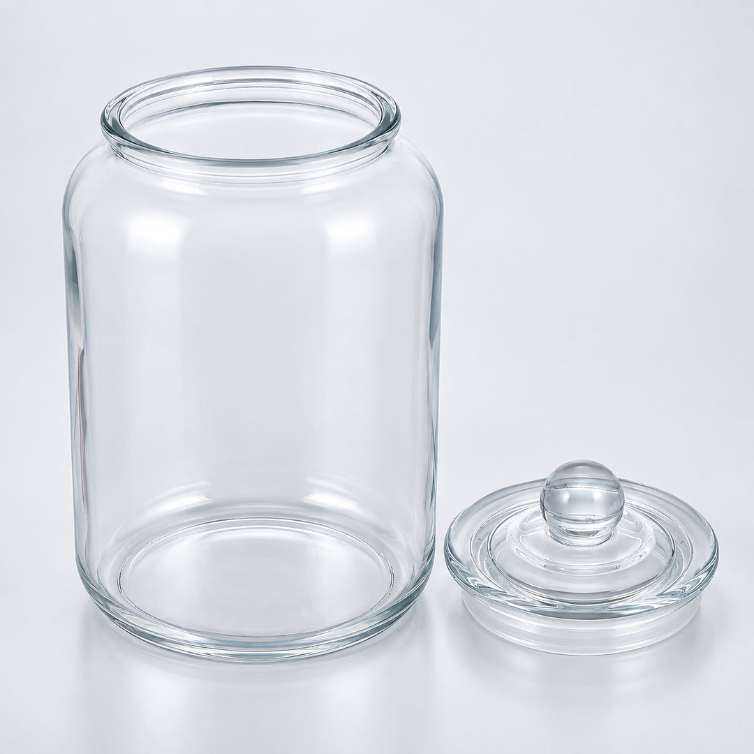 Clear glass jar with a matching glass lid, photographed on a clean white studio background.