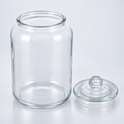 Clear glass jar with a matching glass lid, photographed on a clean white studio background.