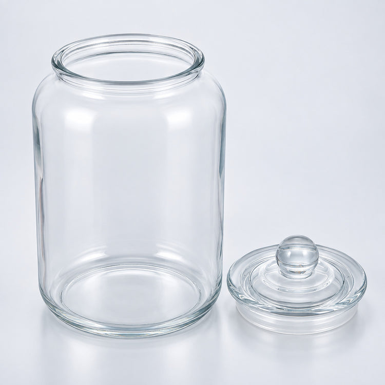 Clear glass jar with a matching glass lid, photographed on a clean white studio background.