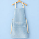One blue striped bib apron with beige straps and divided front pocket.