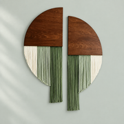 Split wood circle wall decor with cream and green fringe hung apart on sage