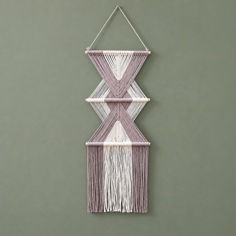 Dusty mauve and cream knotted macrame wall hanging with two diamonds on a sage wall