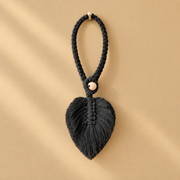 Black studio on ochre, macrame leaf holdbacks in 6 colors, twisted cord, combed flat at the leaf, round pale wooden bead