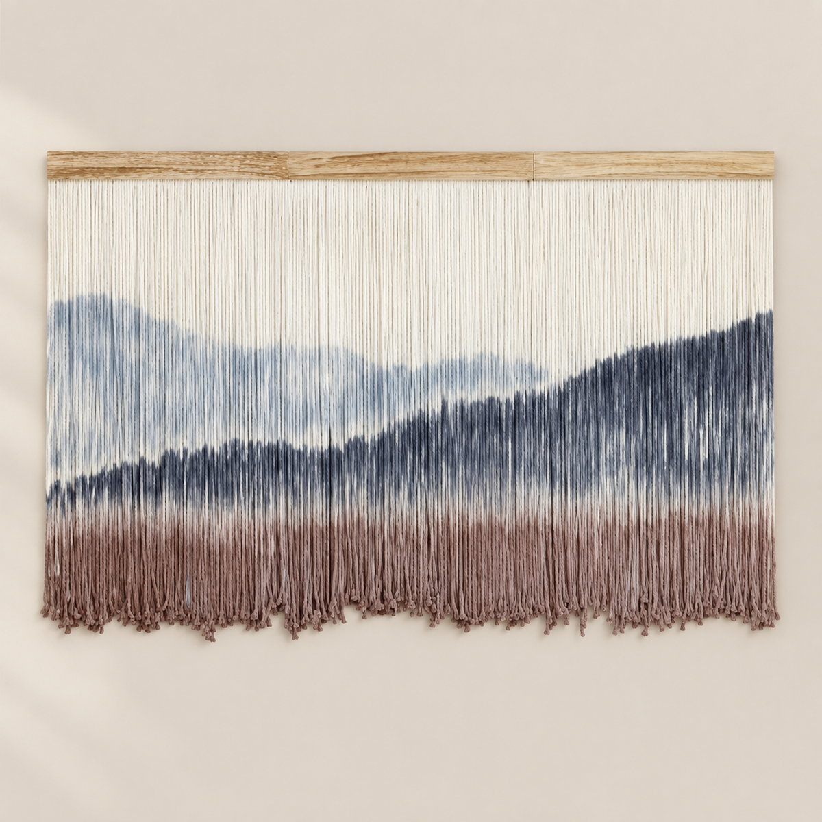 Dip dyed wall hanging with a pale blue sky, navy peaks and dusty rose foreground