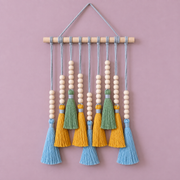 Blue option studio on pink, small beaded tassel row on a dowel