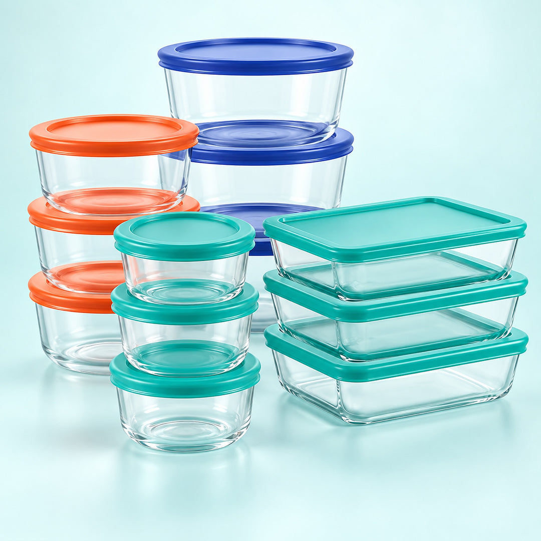 A set of clear glass food storage containers with colorful lids in orange, teal, and blue, arranged on a light blue background.