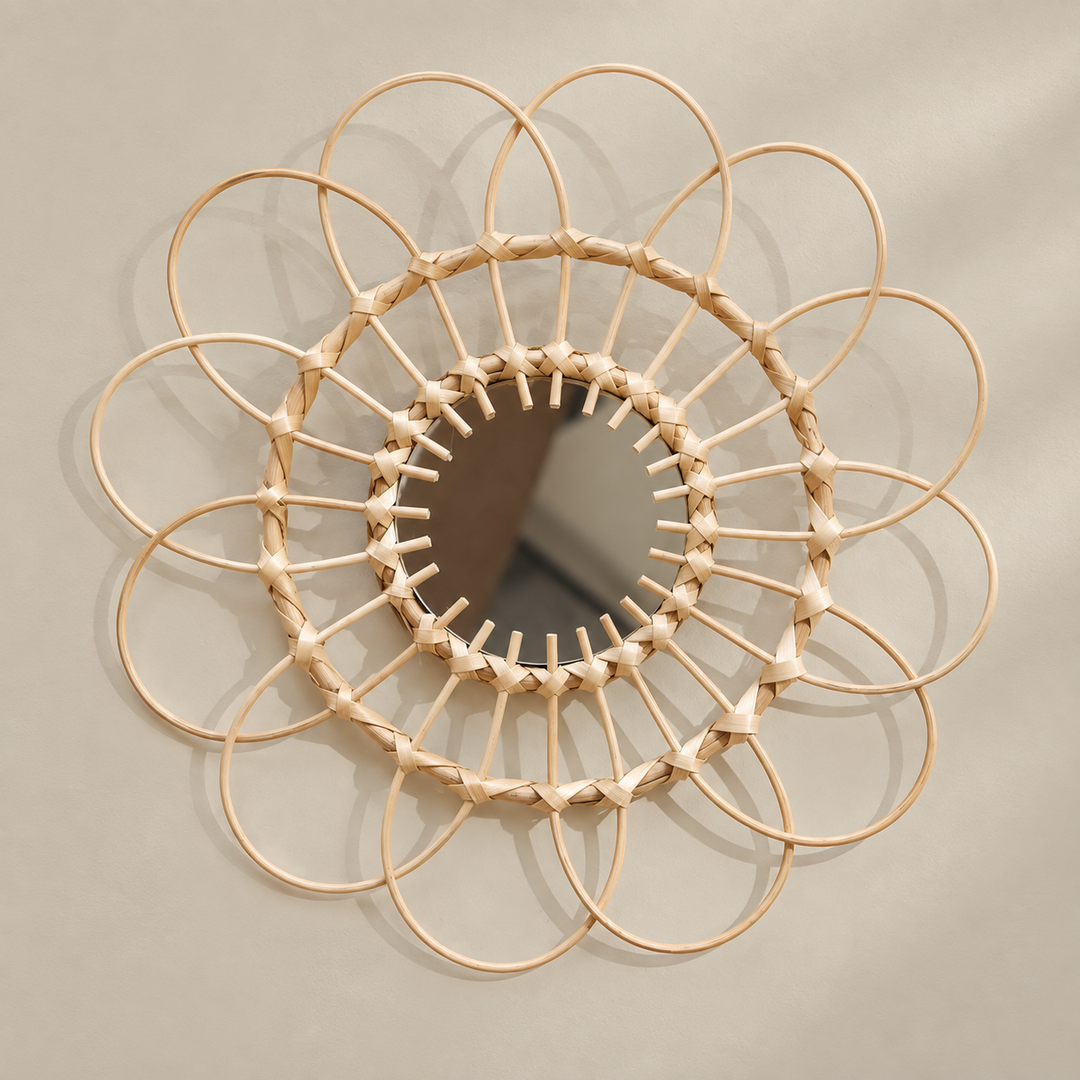 Round natural rattan hoop mirror with a flower shaped ring of hoops on cream