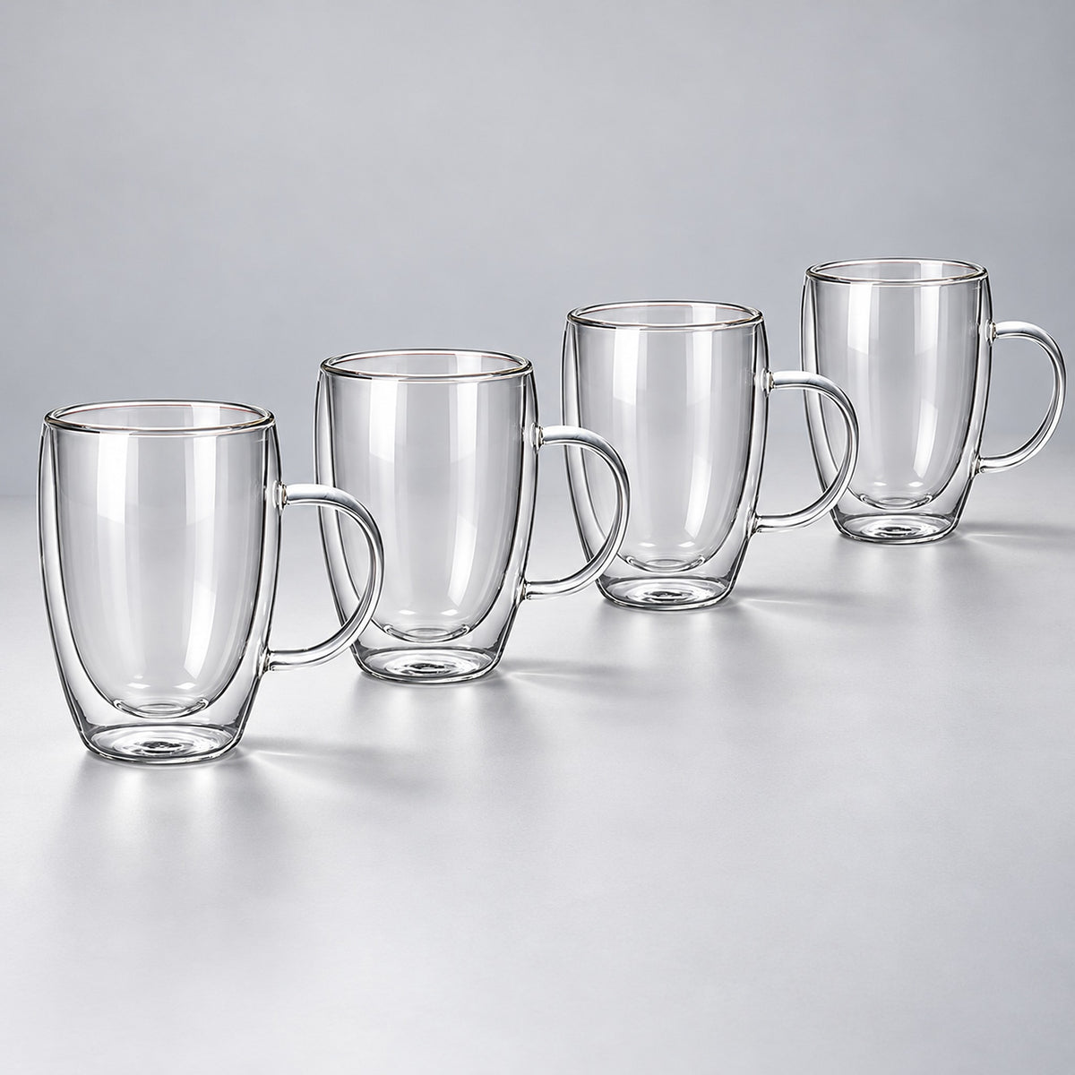 Four empty tall 450 ml clear double-wall glass mugs with handles.