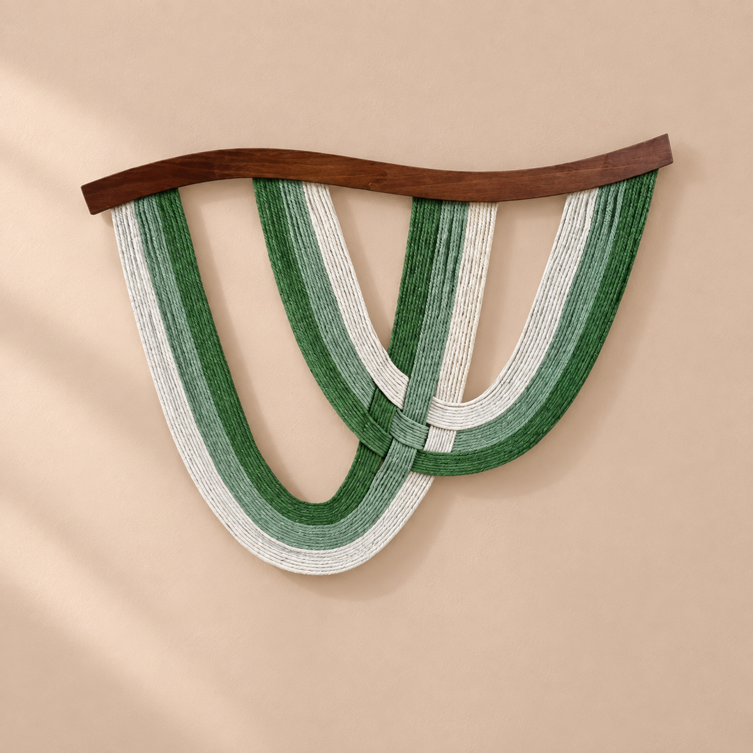 Deep green and cream rope arcs under a curved dark batten on a sand wall