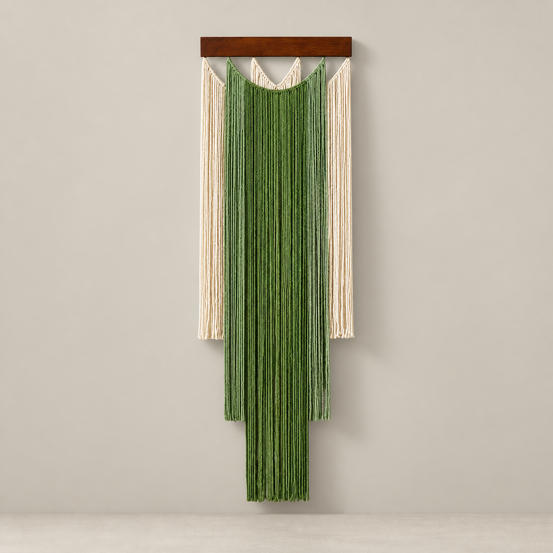 Green and cream stepped fringe wall hanging on a dark batten, pale background