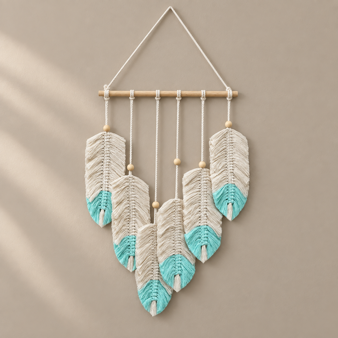 Seven cream macrame feathers with turquoise dipped tips on a wooden dowel