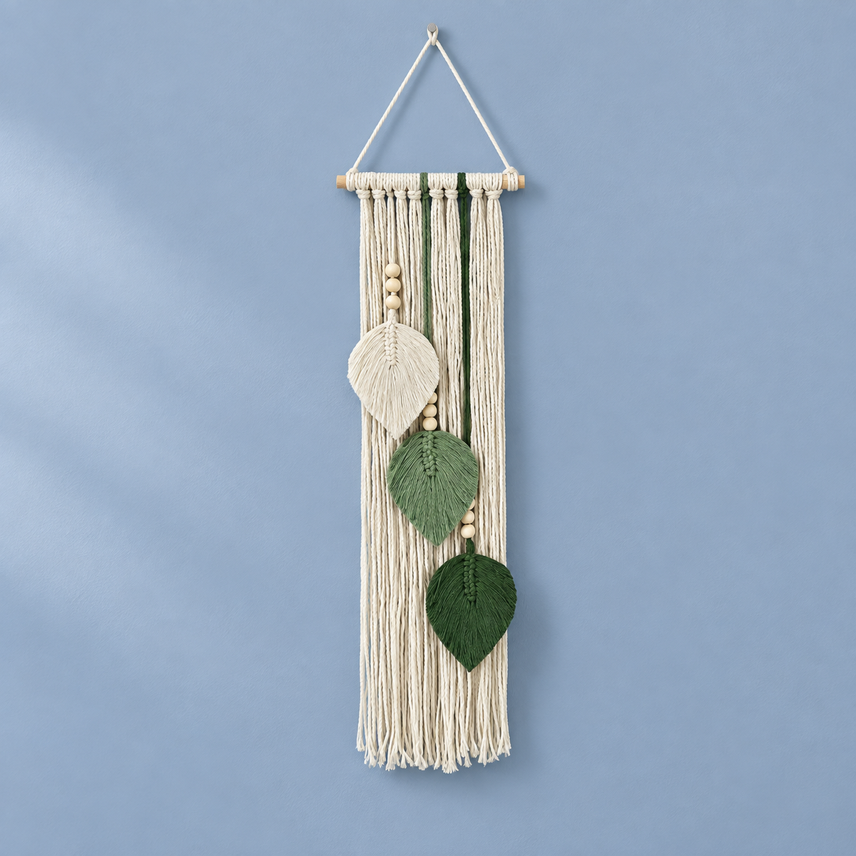 Milky white studio on a blue ground, macrame leaf trio, twisted cord, combed flat at the leaves, pale wooden dowel