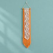 Orange macrame banner with a cream knotted leaf vine down its center on teal