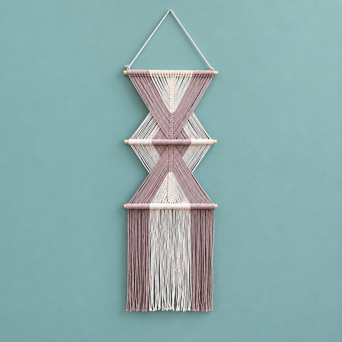 Pink studio on teal, stacked hourglass tiers, twisted cord, short pale dowels