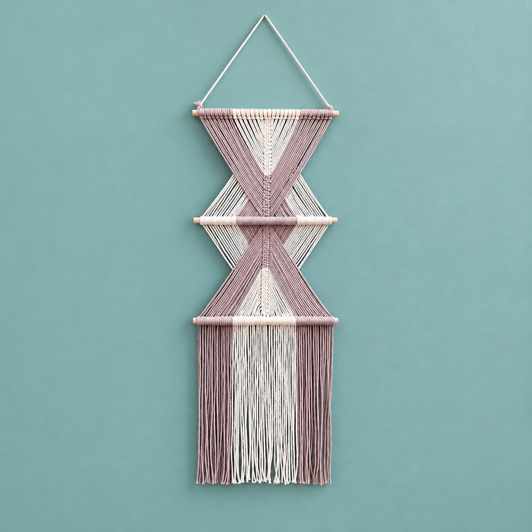 Pink studio on teal, stacked hourglass tiers, twisted cord, short pale dowels