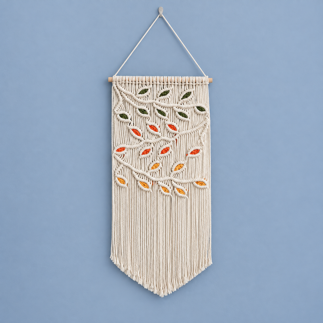 Cream macrame pennant with green, orange, red and mustard knotted leaves