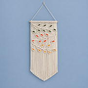 Cream macrame pennant with green, orange, red and mustard knotted leaves