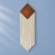 WHITE studio on blue, wood diamond over a narrow chevron fringe