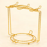 One empty gold twisted-wire cup-and-saucer rack.