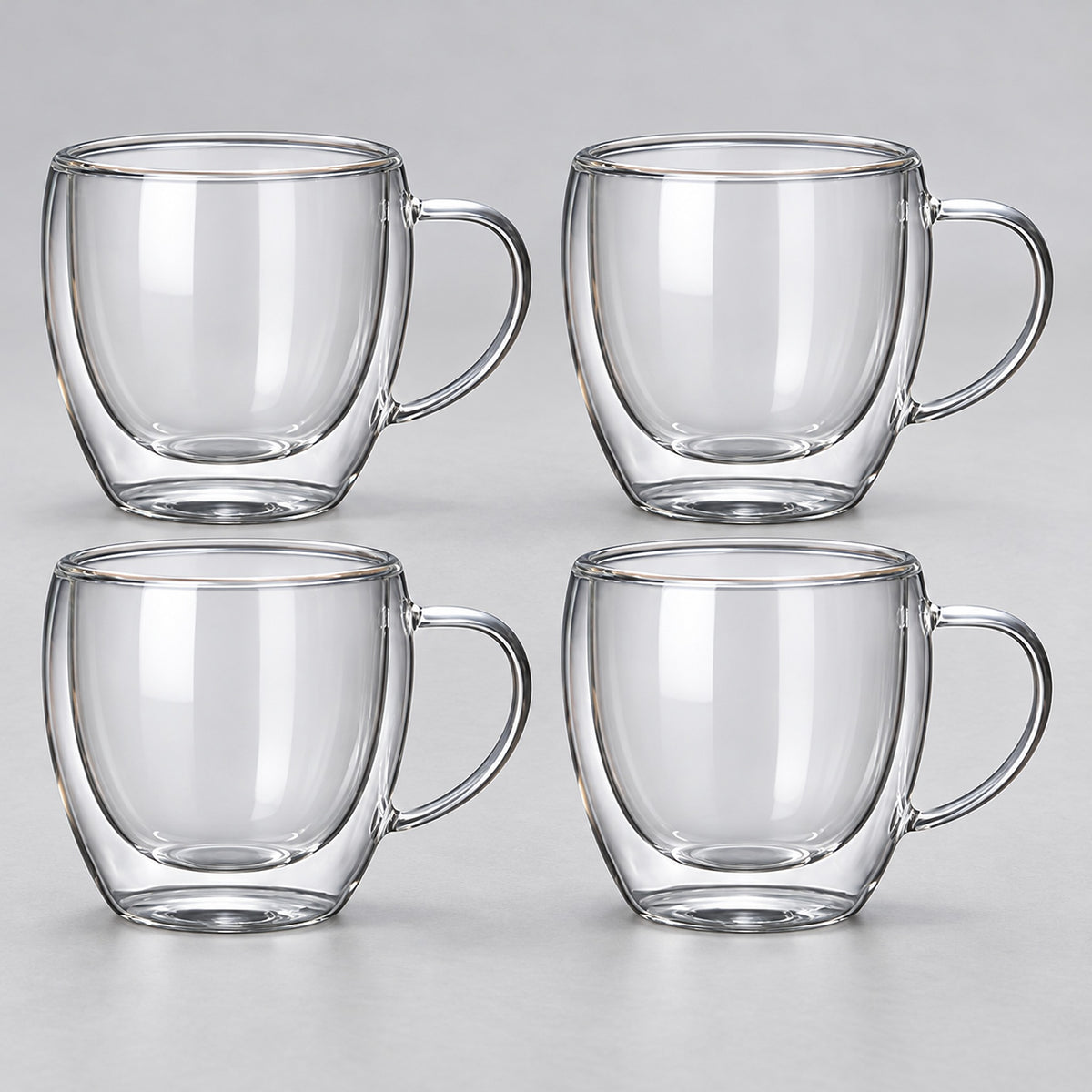 Four empty rounded 250 ml clear double-wall glass mugs with handles.