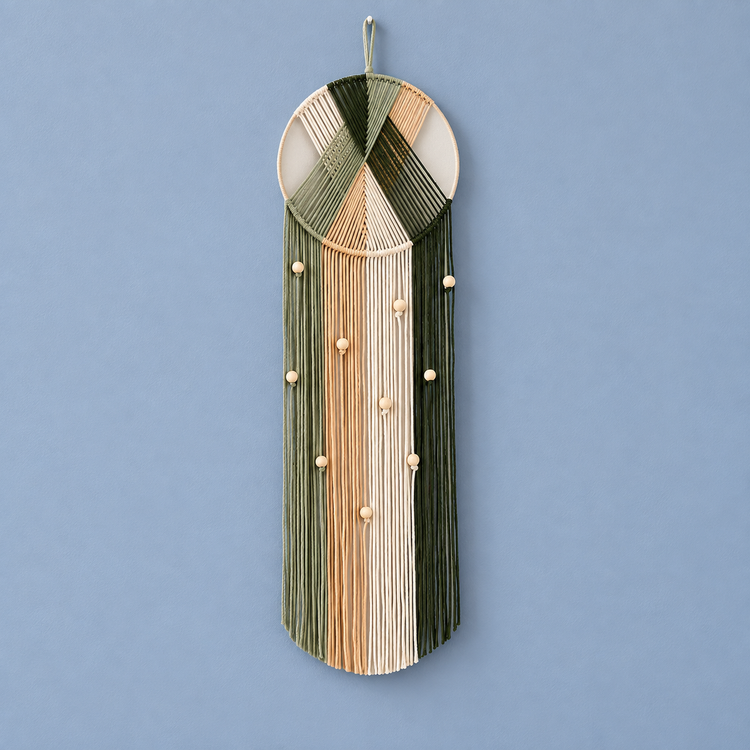 A studio on blue, fanned hoop with fringe, twisted cord, cord-wrapped ring