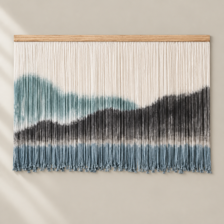 Teal, charcoal and blue gray dip dyed mountain wall hanging on a pale batten
