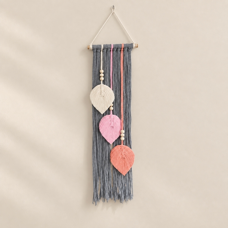Gray studio on a cream ground, macrame leaf trio, twisted cord, combed flat at the leaves, pale wooden dowel