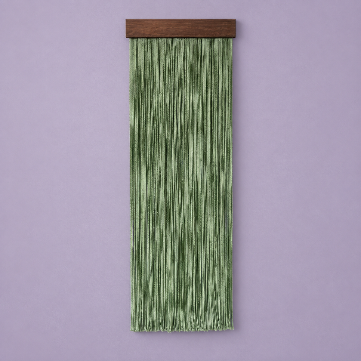 A vertical sage green macrame wall hanging with a dark brown wooden top bar, shown against a solid lavender background.