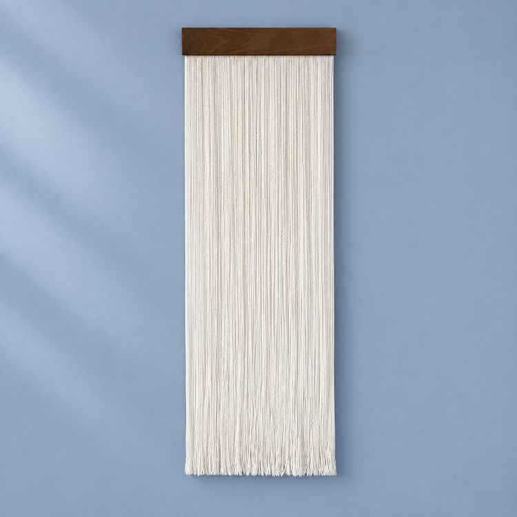 Single cream fine cord fringe panel on a chunky dark batten against blue