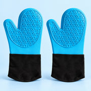 A pair of silicone oven mitts with textured blue backs and black fabric cuffs, displayed side-by-side on a light blue background.
