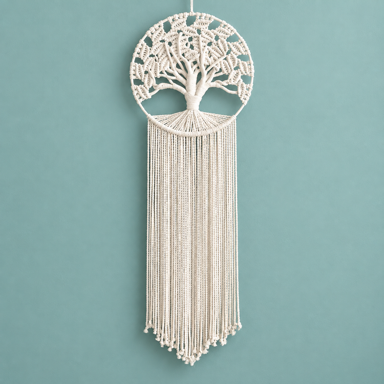 A macrame tree of life wall hanging in off-white cotton cord, suspended against a solid teal background.