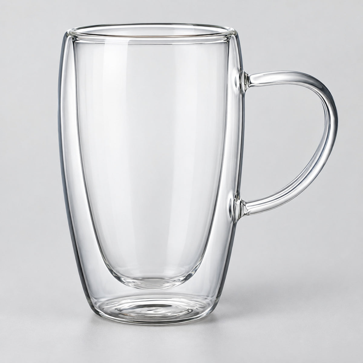 One empty tall 450 ml clear double-wall glass mug with handle.
