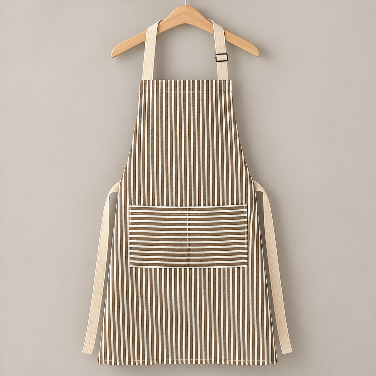 One brown striped bib apron with beige straps and divided front pocket.