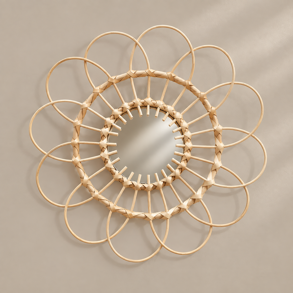 A circular wall mirror with a natural rattan or wicker frame arranged in a sunflower-like pattern, mounted on a neutral beige wall.