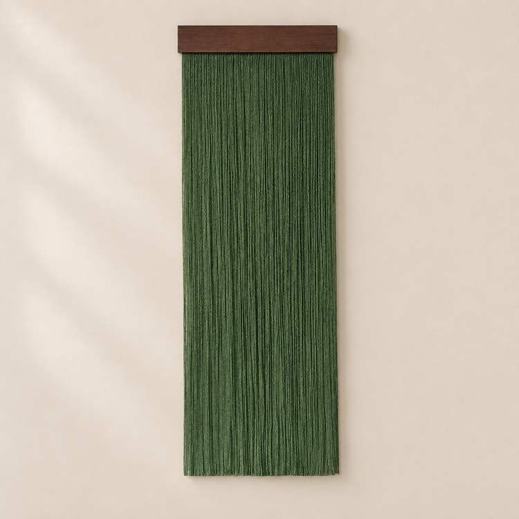 Single forest green fringe panel on a chunky dark batten on a cream wall