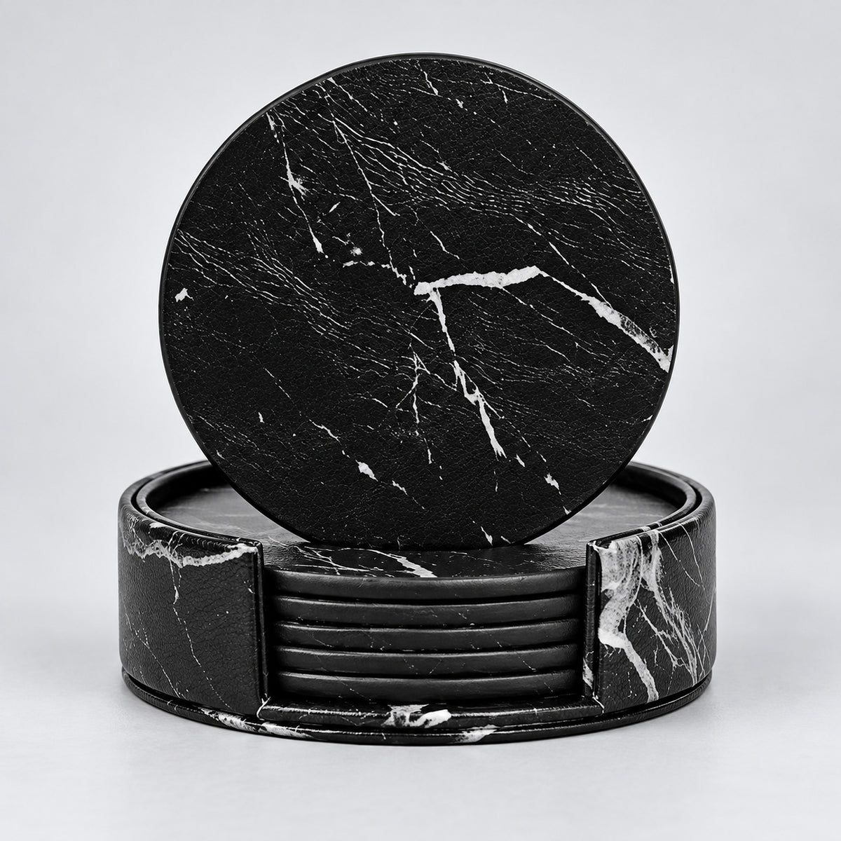 Six black 10 cm artificial-leather coasters with matching holder.